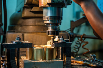 The operation of NC milling machine by technician operator. The shop floor operation by NC milling machine.