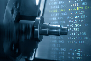 Fototapeta premium The abstract scene CNC lathe machine cutting the metal shaft parts and G-code data background. The hi-technology metal working processing by CNC turning machine .