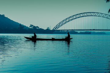 Breathtaking lakeside view with a canoe on the Adomi Bridge in Ghana