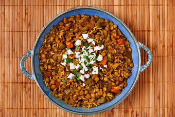 Green lentil soup dish flat lay. Lentil soup with rice, carrot and celery in a plate.