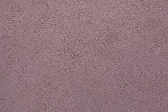 Dirty pink painted stucco wall. Background texture