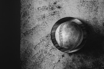 Old baseball background with vintage used ball in black and white with copy space.
