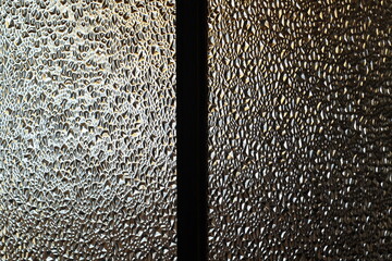 Translucent Glass Close-up Surface with Refractive Light. Uneven Bumpy Semitransparent Texture Background