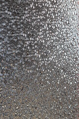 Translucent Glass Close-up Surface with Refractive Light. Uneven Bumpy Semitransparent Texture Background