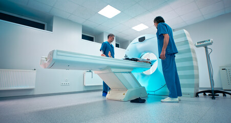 Mature doctors finishing CT scanning of senior man