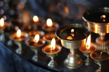 Buddhist Old Altar Candles at Religious 108 Butter Lamp Festival in Temple Monastery. Beautiful Tranquil Scenic View of Oil Lamps and Swaying Flame for Praying 