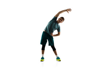 Fototapeta premium Stretching. Young caucasian male model in action, motion isolated on white background with copyspace. Concept of sport, movement, energy and dynamic, healthy lifestyle. Training, practicing. Authentic