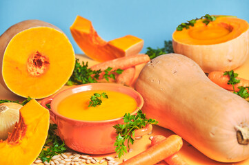 Pumpkin puree on an orange table and where all the orange color predominates like the pumpkin and on a blue background
