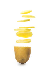Potato slices turning into chips isolated on white background