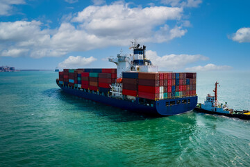 tug boat drag container ship in shipping port area, thailand.