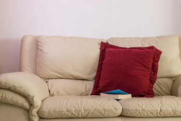 ocher sofa with reading book on it