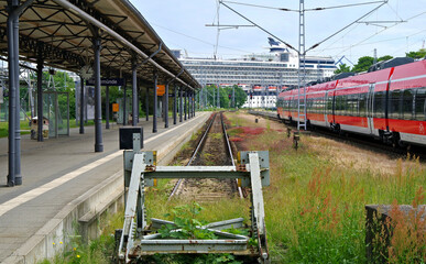 Train station and cruiseship or cruise ship liner in port of Warnemunde, Rostock in Germany