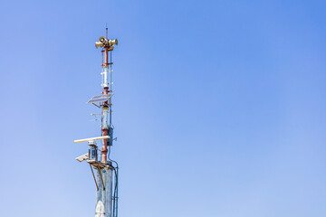 Communication antenna with background of blue sky.