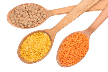 Lentils in wooden spoons isolated on white background