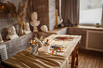 Cozy studio of an artist, paints and brushes.