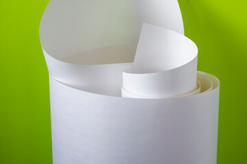 Roll of white paper on a green background.
