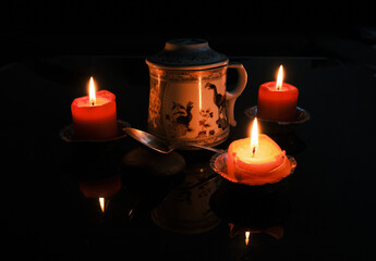 Chinese tea served in a nice teapot around candles