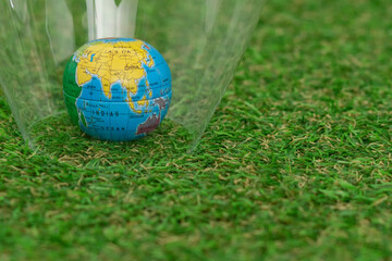 Naklejka premium A globe on the lush green grass. Earth Day.