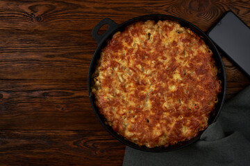 Macaroni with cheese  in a pan on an old wooden table.
