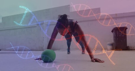 Animation of dna strands spinning over woman doing press ups, exercising with ball in gym - Powered by Adobe