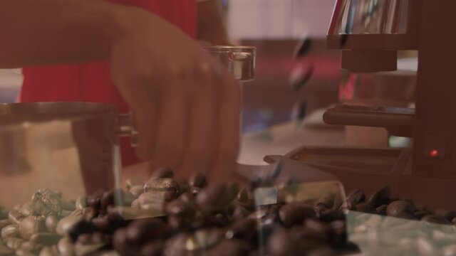 Animation of pouring coffee beans with hands of barista preparing coffee at a cafe