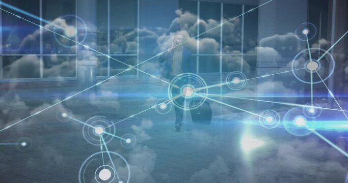 Animation of network of connections and moving clouds with man wheeling suitcase in street