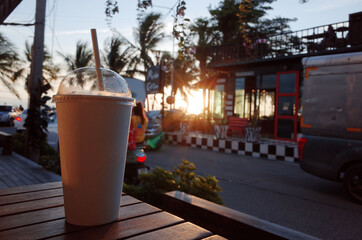 White coffee mugs are placed on the table against the natural background.
