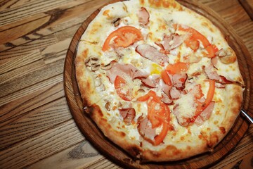 Top view on tasty traditional Adjarian Khachapuri - open baked pie with meat and pepperyolk on wooden tray. Traditional georgian food