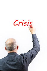 Executive writing the word crisis in red on a white background