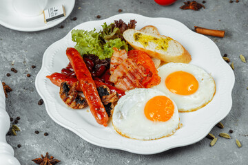 Fried breakfast with bacon, sausages and baked beans