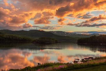 Fototapeta na wymiar reflections at dawn on the lake of Vuoggatjalme, sweden