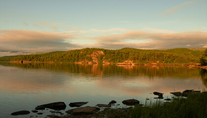 reflections at dawn on the lake of Vuoggatjalme, sweden