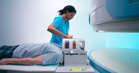 Senior patient during MRI procedure with black doctor