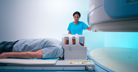 Senior patient during MRI procedure with black doctor