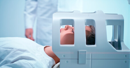 Crop doctor preparing boy for MRI procedure in lab