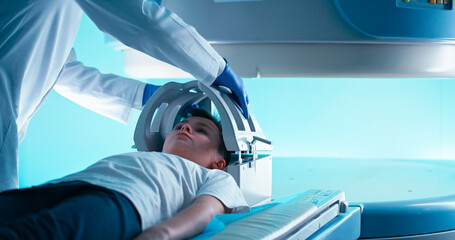 Crop doctor in gloves starting MRI scanning of kid