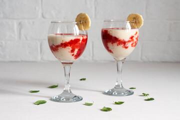 Two glasses of banana strawberry smoothie. Healthy drink
