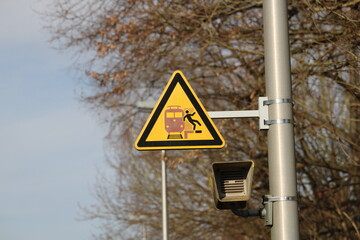Sign for a warning about the distance from the platform to the train track with loudspeaker