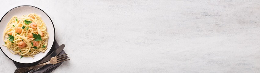 Spaghetti shrimp scampi in a plate banner with place for text
