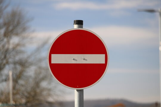 Road sign prohibiting entry close up against a blue sky