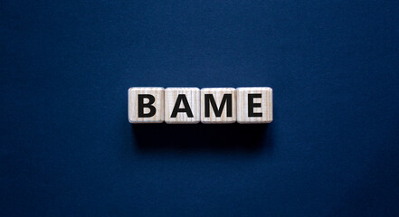 BAME symbol. Abbreviation BAME, black, asian and minority ethnic on wooden cubes. Beautiful grey...