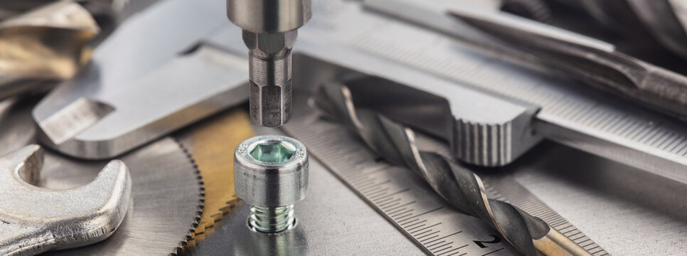 Hex drill bit screw hex bolt in metal steel plate with ruler and caliper. Spanner, bolt, screw and nuts. - Powered by Adobe