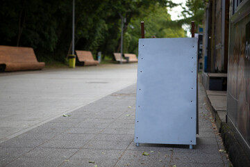 Blank advertising board on city street.