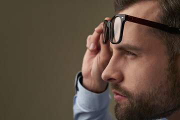 Man struggling to see something without spectacles