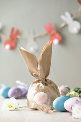 Pom Pom Easter Bunny Craft. Easter bunny decoration paper gift. DIY holiday garland of colorful rabbits