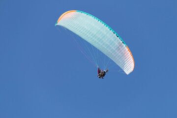 Twin paraglider. Paragliding against the blue sky.