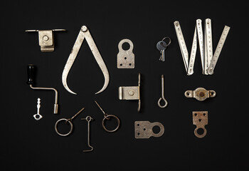 Flat lay rusted iron metal tools on dark background