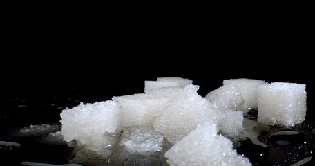 Dissolving sweet sugar pieces in water. Concept of chemical industry. Manufacture of plastics,...