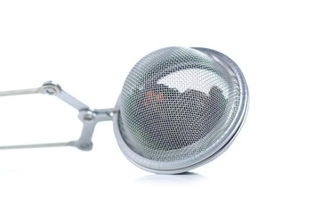 Metal tea strainer with tea leaf on white background isolation