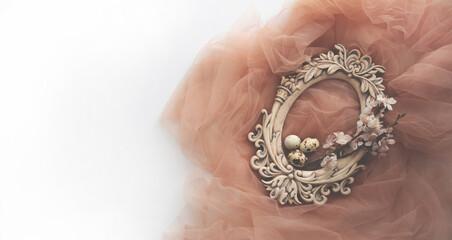 Old oval carved frame with spring flowers and eggs on pastel background. Spring flowers composition with copy space.
